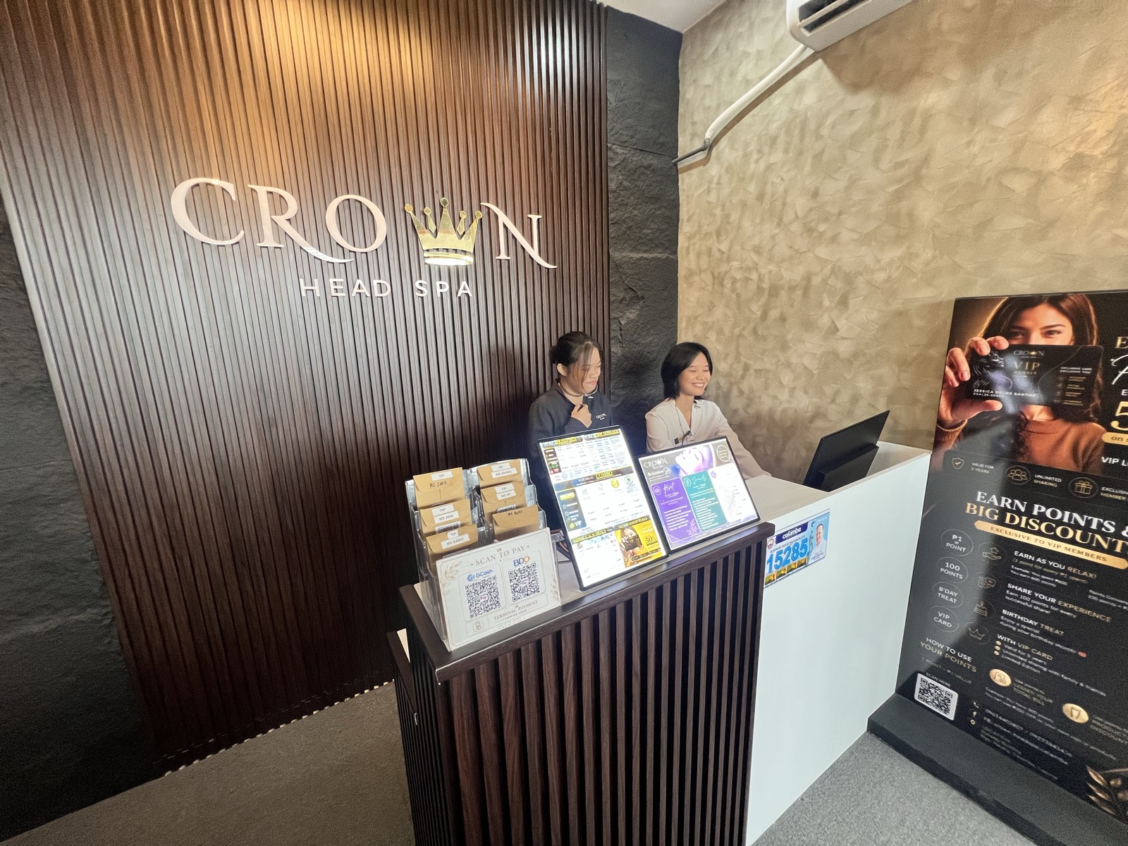 Staff at reception with VIP loyalty card promotion