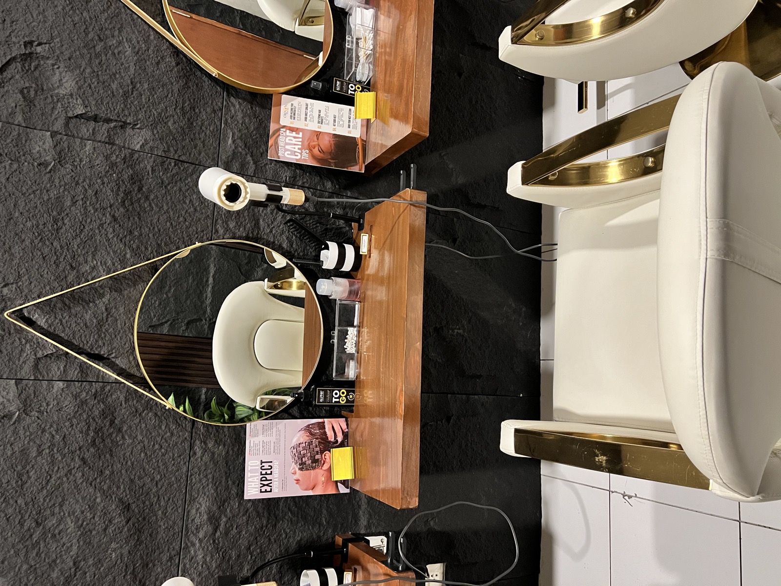 Styling station closeup with gold-framed mirrors