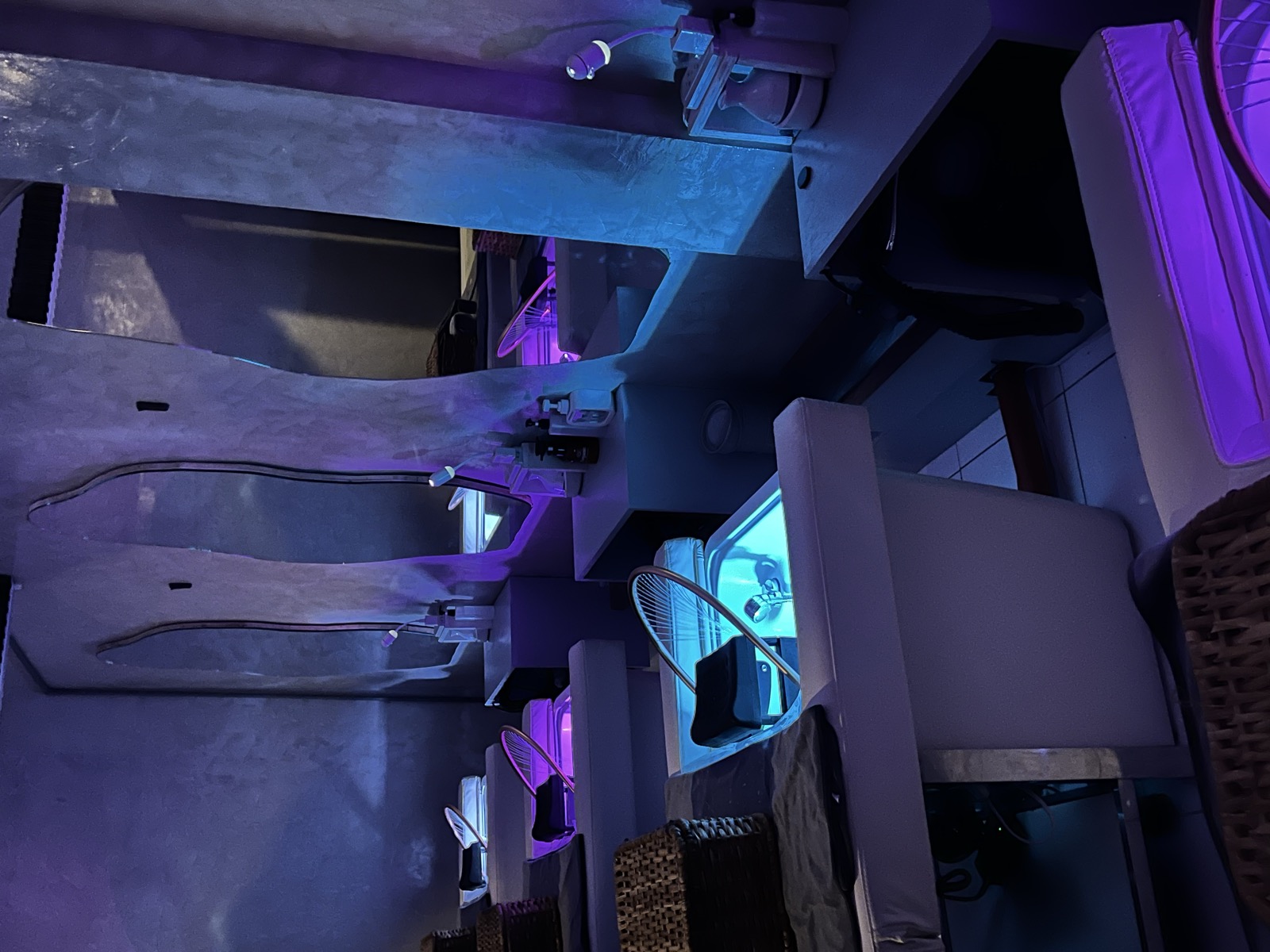Treatment cubicles with arched mirrors and purple lighting