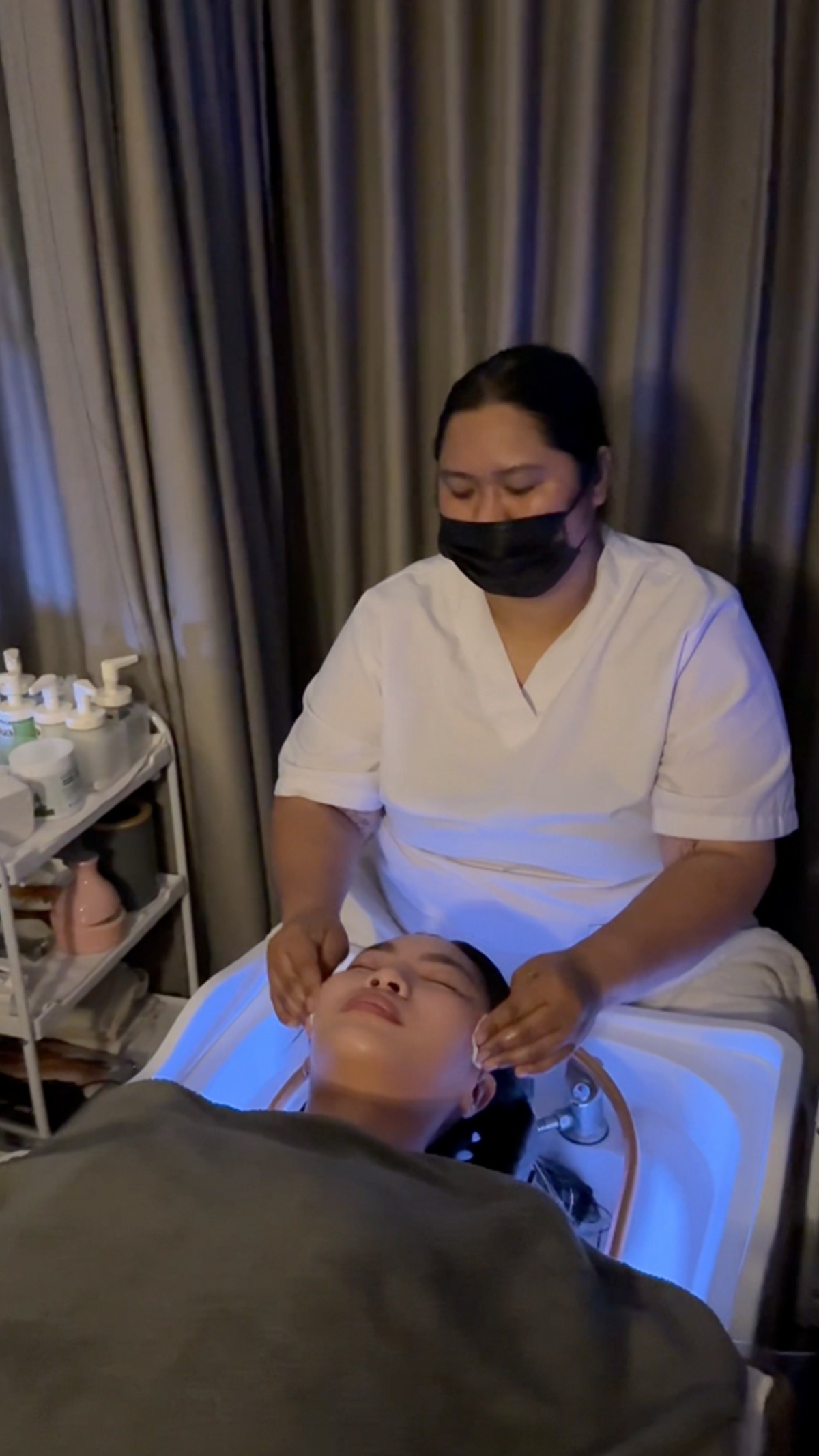 Therapist performing a facial cleanse
